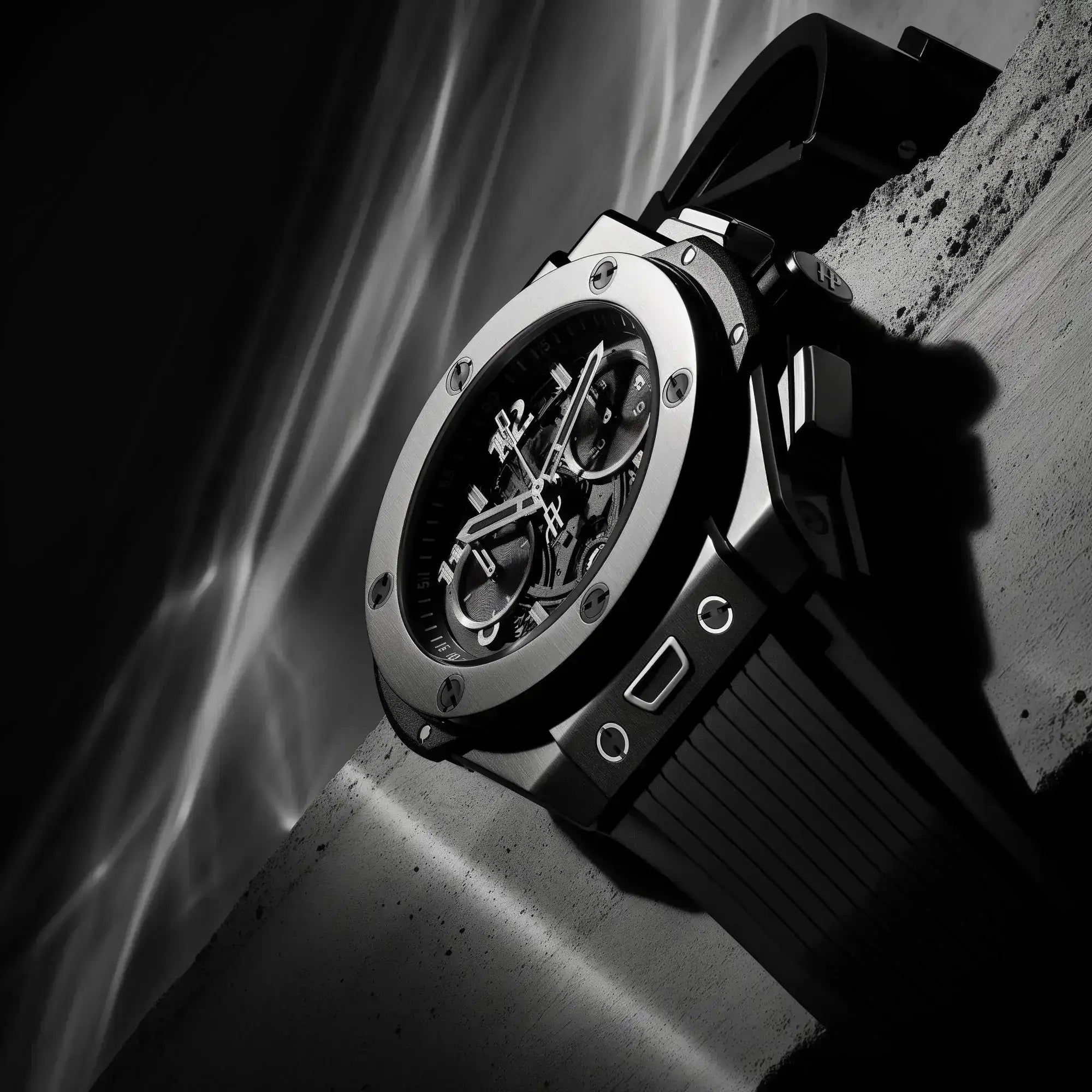 Luxury watch with a black strap on a textured surface